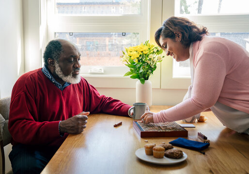 
Happy Multiracial Senior Couple Playing Scrabble Together at Home