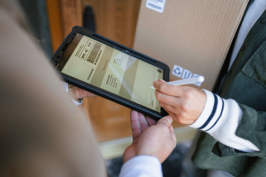The postman delivers the parcel to the customer
