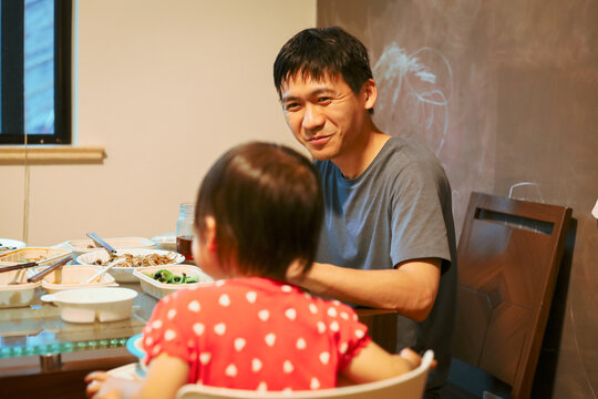 Asian father with child at meal time