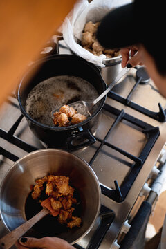 A chef frying chicken 
