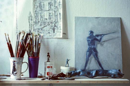 Oil canvas Painting picturing a toy soldier next to paint Brushes 
