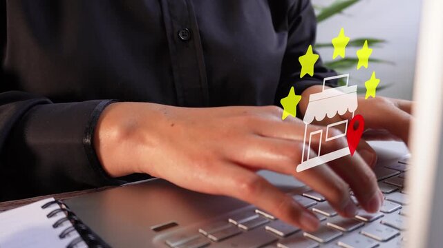 Close-up of a businesswoman working on her computer with an animation of a five-star rating for a local store.