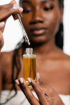 A woman holds a cosmetic product in her hands