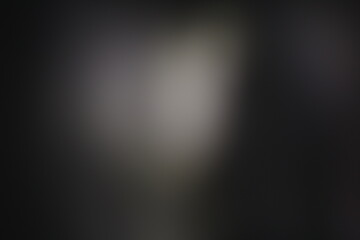 Una toma de cerca de un fondo abstracto de color gris y negro con un desenfoque ligero © Elika R