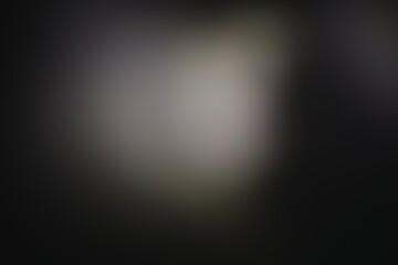 Una toma de cerca de un fondo abstracto de color gris y negro con un desenfoque ligero © Elika R