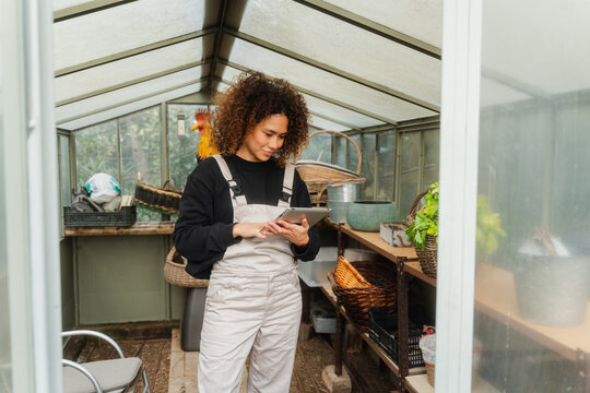 Smiling Woman Using Digital Tablet In A Storage Room