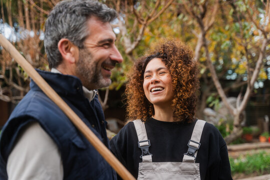 Happy Gardeners Engaged In Cheerful Conversation