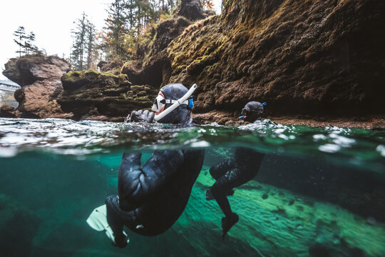 two diver in clear river