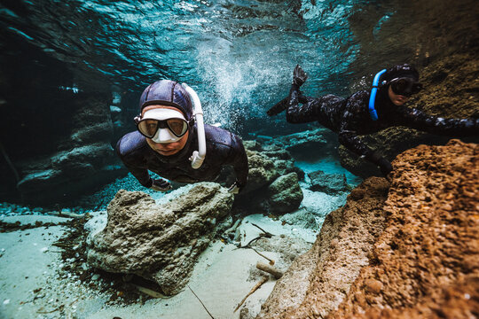 two divers in a river