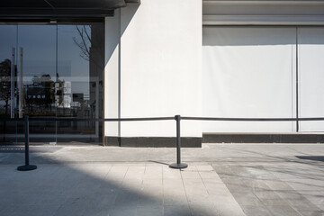 Fototapeta premium Modern building exterior facade with glass entrance door and retractable barrier tape