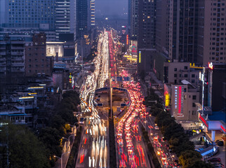 Busy Night Traffic on City Street Overlooking Asian Downtown © TranPhuoc