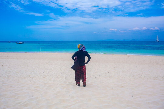 young woman walking on the beach