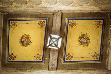 Cortona, Tuscany, Italy: Ornate ceiling with floral paintings and light fixture