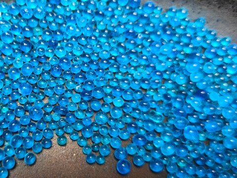 Close-up of blue silica gel desiccant beads used for moisture absorption and protection