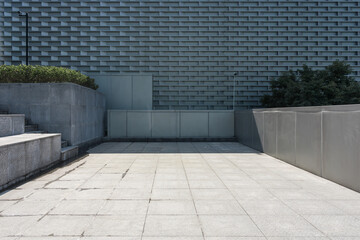 Modern architectural gray brick wall with concrete steps and plaza space © zhu difeng