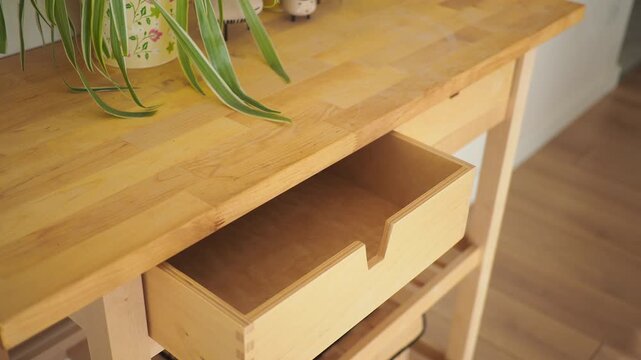 Empty drawer on a wooden table in a bright room