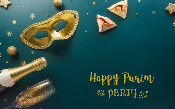 Happy Purim carnival decoration concept made from golden mask star and glitter on dark background. (Happy Purim in Hebrew, jewish holiday celebrate)
