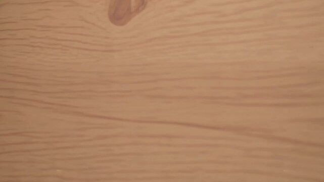 Light brown wooden surface with visible grain and knots
