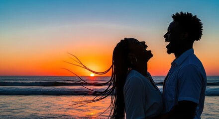 Fototapeta premium Silhouette Serenity: A joyful african american couple embrace the sunset and happiness on a