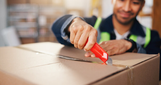 Man, hands and cutting with box for logistics, packaging or freight safety in small business depot. Male person, open or unboxing with parcel or cargo for supply chain, distribution or delivery check