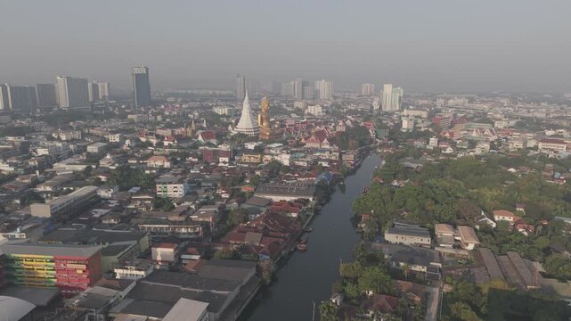 Golden buddha statue at wat paknam phasi charoen sunset sky with rivaer aerial view sightseeing travel in Bangkok Thailand 