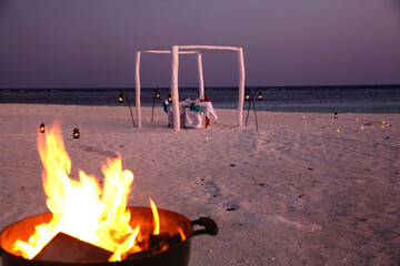 Romantic Beach Wedding Setup with Bonfire at Maldives Sunset © HoangVan