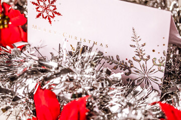 Elegant Christmas Card with Red Poinsettias and Silver Snowflakes