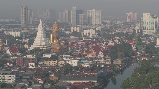 Golden buddha statue at wat paknam phasi charoen sunset sky with rivaer aerial view sightseeing travel in Bangkok Thailand 