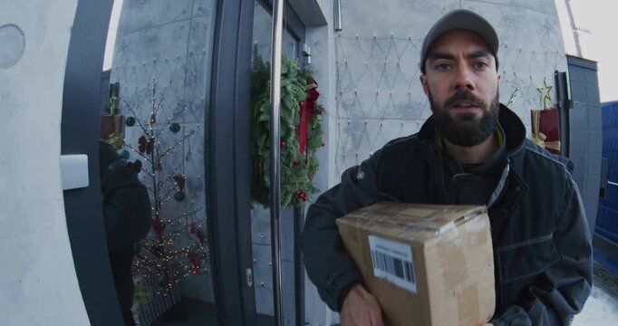 Male Courier in Uniform Delivers Cardboard Box Female Customer. Woman Provides Digital Signature on Tablet For Delivery Confirmation. Concept Modern Contactless Delivery, and Secure Home Logistics.