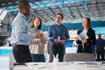Diverse Team Meeting At Sales And Marketing Booth