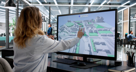 Female GIS Engineer Mapping City On Computer