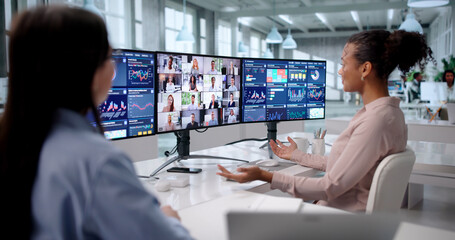 Two Young Women Of Diverse Background Analyzing Data