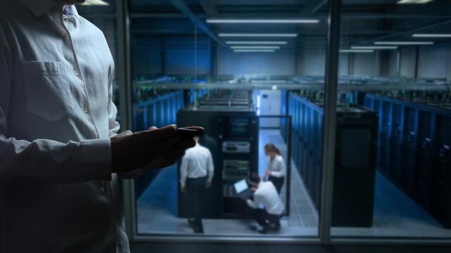 Focused Team Of Technicians Performing Urgent Repairs On Server Racks In Data Center Environment