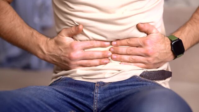 Patient Holding Suffering From Stomach Pain. Stomachache Discomfort. Gastritis Or Appendicitis Illness Symptom. Medical Problems