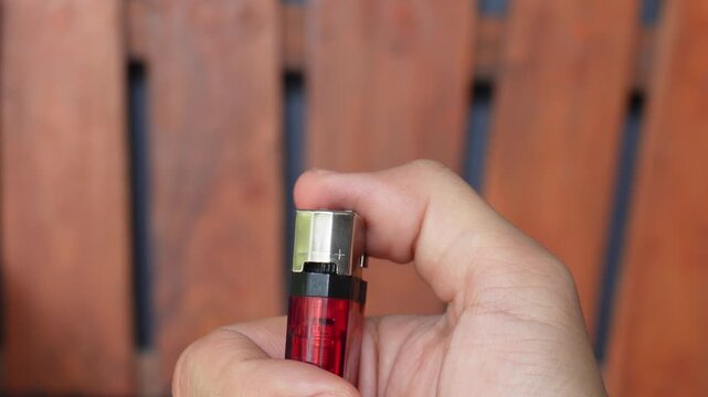 close up of hand holding a cigarette lighter