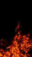 Vertical texture. Fire on isolated background. Perfect explosion effect for decoration and covering on black background. Concept burn flame and light texture overlays