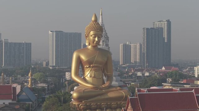 Golden buddha statue at wat paknam phasi charoen sunset sky with rivaer aerial view sightseeing travel in Bangkok Thailand 