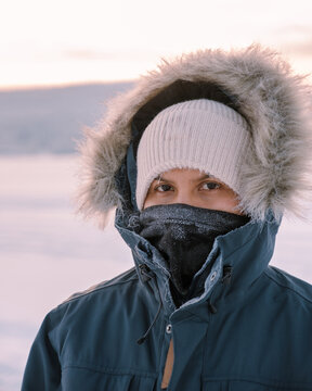 Charming winter scene in Akaslompolo Village showcasing a traveler in Laplands pristine snow