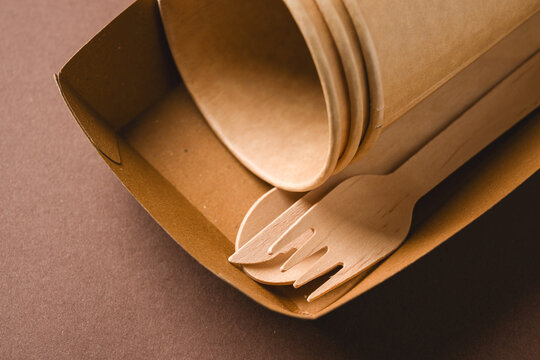 Eco takeaway packaging with wooden cutlery and paper cups