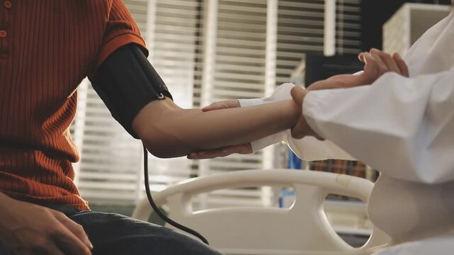 Doctor Measuring arterial blood pressure with man patient on arm Health care in hospital