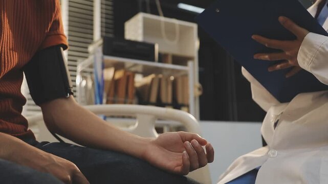 Doctor Measuring arterial blood pressure with man patient on arm Health care in hospital