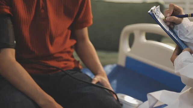 Doctor Measuring arterial blood pressure with man patient on arm Health care in hospital