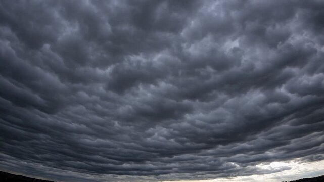 Dramatic mammatus clouds forming a textured, ominous sky, hinting at an approaching storm.