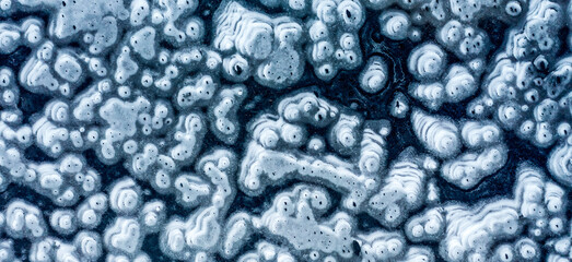Top view of the ice surface with strange patterns. Abstract designs and shapes. © Leonid Tit