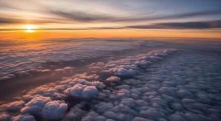 Dramatic sunset view above clouds at dusk with golden sunlight