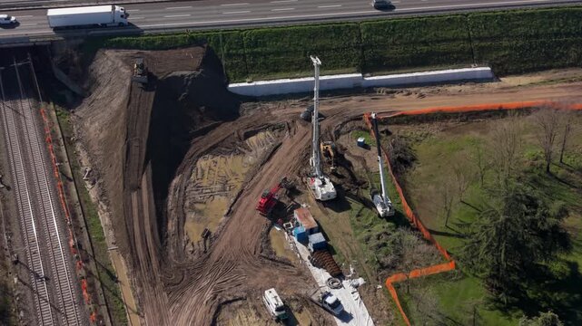 Aerial view of highway underpass construction site with heavy machinery