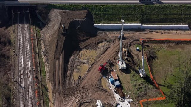 Aerial view of drilling rigs at construction site near railway
