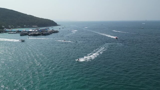 태국 파타야 산호섬의 투명한 에메랄드빛 바다와 제트스키, 바나나보트를 즐기는 역동적인 해변 휴양지 드론 항공 촬영
