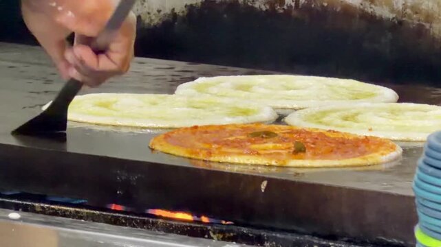 Flipping ghee dosas at a time