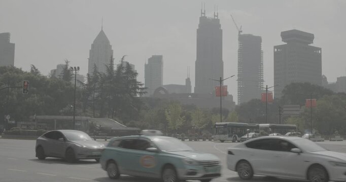 Public bus in motion against a backdrop of tall skyscrapers and blue skies. Shanghai, China